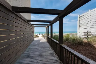a boardwalk to the beach from a beach house at Rooftop Views of The Gulf! 1800 Square Foot Private Rooftop Terrace! in Panama City Beach