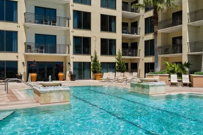 a swimming pool in front of a building at Rooftop Views of The Gulf! 1800 Square Foot Private Rooftop Terrace! in Panama City Beach
