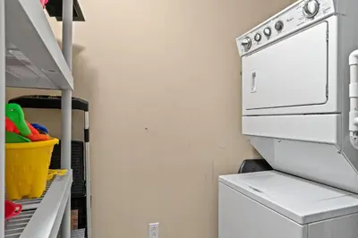 a laundry room with a washer and dryer at Rooftop Views of The Gulf! 1800 Square Foot Private Rooftop Terrace! in Panama City Beach