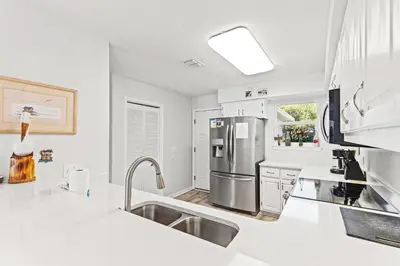 a kitchen with white counters and stainless steel appliances at Vacation in This Gorgeous 2-Story Home! 3 BR 3 BA! Sleeps 8! in Panama City