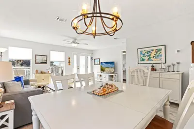 a dining room and living room with a white table at Vacation in This Gorgeous 2-Story Home! 3 BR 3 BA! Sleeps 8! in Panama City