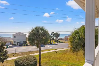 a view of a street with palm trees and the ocean at Vacation in This Gorgeous 2-Story Home! 3 BR 3 BA! Sleeps 8! in Panama City