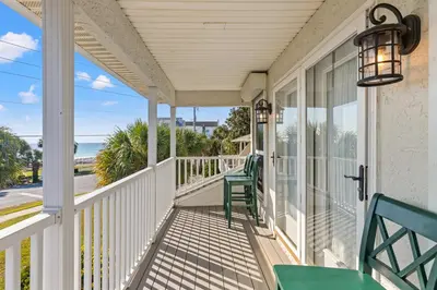 a porch with chairs and a view of the ocean at Vacation in This Gorgeous 2-Story Home! 3 BR 3 BA! Sleeps 8! in Panama City