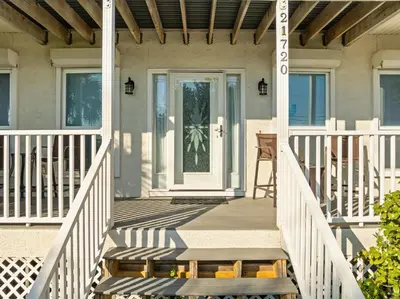 a front porch of a home with a white door at Vacation in This Gorgeous 2-Story Home! 3 BR 3 BA! Sleeps 8! in Panama City