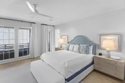a white bedroom with a large bed and a window at Private Pool, Gulf Views & Luxurious Features Throughout this Lovely Residence condo in Panama City Beach