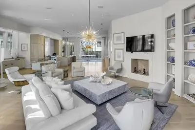 a living room with white furniture and a fireplace at Private Pool, Gulf Views & Luxurious Features Throughout this Lovely Residence condo in Panama City Beach