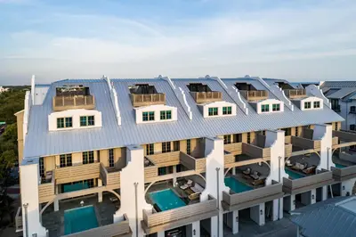 an aerial view of a building with solar panels on its roof at Private Pool, Gulf Views & Luxurious Features Throughout this Lovely Residence condo in Panama City Beach