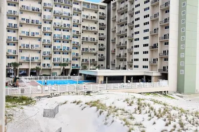a view of a large apartment building from the beach at Pinnacle Port C1-502 in Panama City Beach