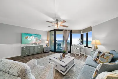 a living room with a couch and a table at Newly Renovated Beachfront Condo! Free Beach Chair Service! by Dolce Vita Getaways PCB in Panama City Beach