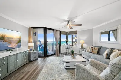 a living room with a couch and a tv at Newly Renovated Beachfront Condo! Free Beach Chair Service! by Dolce Vita Getaways PCB in Panama City Beach