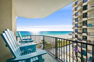 a balcony with two chairs and the ocean at Newly Renovated Beachfront Condo! Free Beach Chair Service! by Dolce Vita Getaways PCB in Panama City Beach