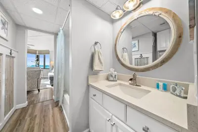a bathroom with a sink and a mirror at Newly Renovated Beachfront Condo! Free Beach Chair Service! by Dolce Vita Getaways PCB in Panama City Beach