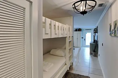 a room with white shelves and a hallway at Wendwood #E2 in Panama City Beach