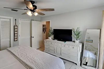 a bedroom with a bed and a television on a dresser at Wendwood #E2 in Panama City Beach