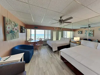 a living room with a bed and a couch at Continental 319-320 in Panama City Beach