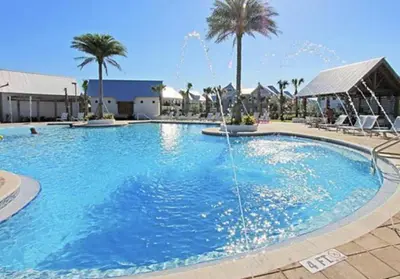 a large swimming pool with a water fountain at Current Affairs Brand New 2 BR Townhome in Prominence Golf Cart Included in Inlet Beach