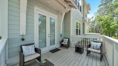 a front porch of a house with two chairs at Aint Nothin Wrong With Getting Your Sun Daze On in Panama City Beach