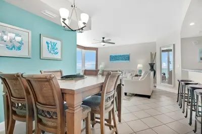 a dining room and kitchen with a table and chairs at Aqua Resort 811 in Panama City Beach
