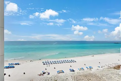 a view of a beach with umbrellas and the ocean at Aqua Resort 811 in Panama City Beach