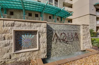 a wall with the word now painted on it in front of a building at Aqua Resort 811 in Panama City Beach