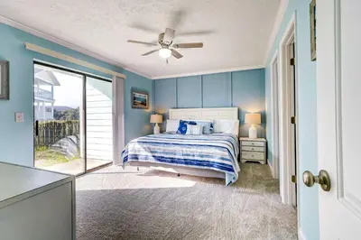 a bedroom with a bed and a ceiling fan at Walkable Panama City Beach Condo with Pool Access! in Panama City Beach