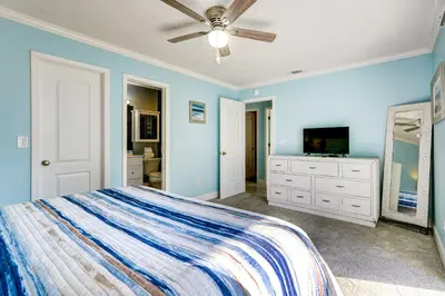 a bedroom with a bed and a flat screen tv at Walkable Panama City Beach Condo with Pool Access! in Panama City Beach