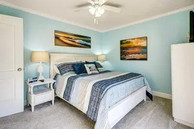 a bedroom with a bed and a ceiling fan at Walkable Panama City Beach Condo with Pool Access! in Panama City Beach
