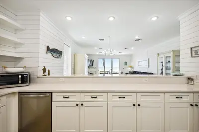 a kitchen with white cabinets and a microwave at Just Beachy - 5 Bedroom 5 Bathroom Beach Front Home! Sleeps 20 home in Panama City Beach