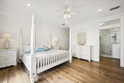 a white bedroom with a bed and two dressers at Just Beachy - 5 Bedroom 5 Bathroom Beach Front Home! Sleeps 20 home in Panama City Beach