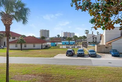 a group of cars parked in a parking lot at Horizon South 8B2- Sunshine Gardens in Panama City Beach