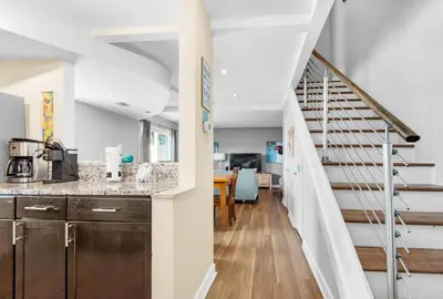 a kitchen with a counter top and a staircase at Horizon South 8B2- Sunshine Gardens in Panama City Beach