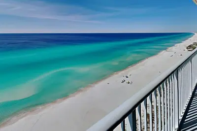 a view of the beach and the ocean from a balcony at Palazzo #1407 in Panama City Beach