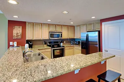a kitchen with a sink and a counter top at Palazzo #1407 in Panama City Beach