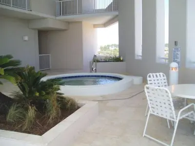 a pool in the middle of a building with a table and chairs at Palazzo #1407 in Panama City Beach