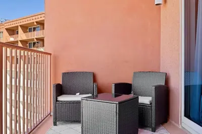two chairs and a table on a balcony at Modern Beachfront Condo on the Beach Sleeps 6! by Dolce Vita Getaways PCB in Panama City Beach