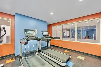 a gym with two treadmills in a room at Modern Beachfront Condo on the Beach Sleeps 6! by Dolce Vita Getaways PCB in Panama City Beach