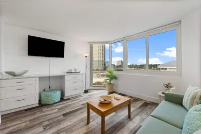 a living room with a couch and a table at Top of the Gulf 410 Beach Front Condo - Renovated! in Panama City Beach