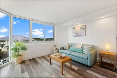 a living room with a couch and a table at Top of the Gulf 410 Beach Front Condo - Renovated! in Panama City Beach