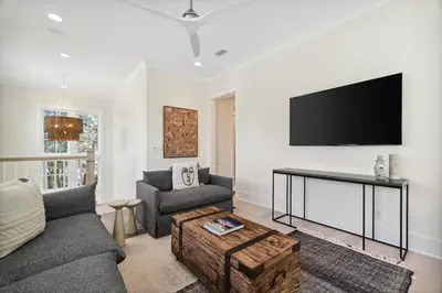 a living room with a couch and a table at 30A Beach House - Harlie's House by Panhandle Getaways in Inlet Beach