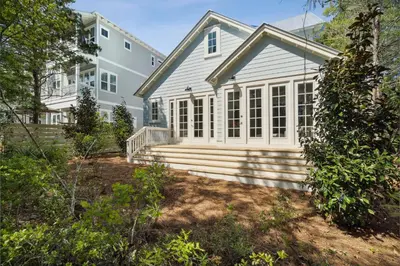 a house with a porch and stairs in front of it at 30A Beach House - Harlie's House by Panhandle Getaways in Inlet Beach