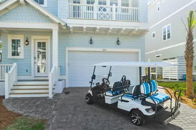 a golf cart parked in front of a house at 30A Beach House - Harlie's House by Panhandle Getaways in Inlet Beach