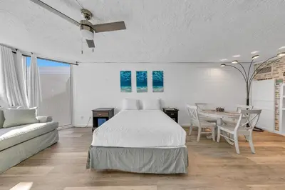 a bedroom with a bed and a table and a couch at Top of the Gulf 811 in Panama City Beach