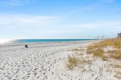 a beach with a trashcan sitting on the sand at Top of the Gulf 811 in Panama City Beach