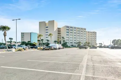 an empty parking lot with a large building in the background at Top of the Gulf 811 in Panama City Beach