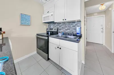 a kitchen with a sink and a stove at Top of the Gulf 825 in Panama City Beach