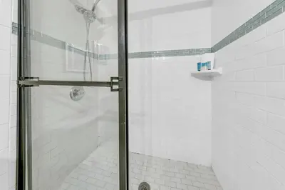 a shower with a glass door in a bathroom at Top of the Gulf 825 in Panama City Beach