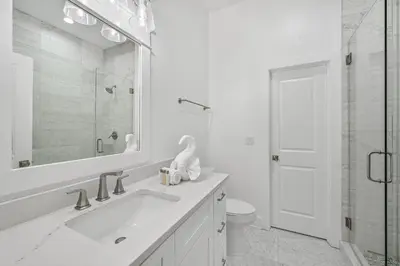 a white bathroom with a sink and a shower at La Joya Azul in Inlet Beach