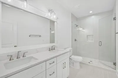 a white bathroom with a sink and a toilet at La Joya Azul in Inlet Beach