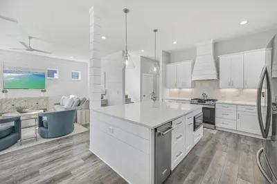 a large kitchen with white cabinets and a kitchen island at La Joya Azul in Inlet Beach