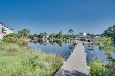 a dock on a lake with boats in the water at St Thomas Square by Panhandle Getaways in Panama City Beach